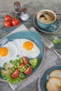 Fried eggs,  bacon, tomato, toast and a cup of coffee Royalty Free Stock Photo