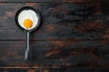 Fried eggs with bacon and vegetables in cast iron frying pan  on old dark wooden table background  top view flat lay   with space Royalty Free Stock Photo