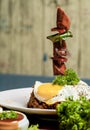 fried eggs with bacon and vegetables on a white plate in a restaurant Royalty Free Stock Photo