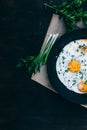 Fried eggs in cast iron frying pan on dark wooden background Royalty Free Stock Photo