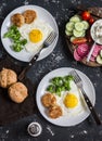 Fried eggs, chicken meatballs, vegetables, and yogurt sauce on a dark background. Healthy lunch Royalty Free Stock Photo