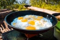 Fried eggs on fire in a hike outside the city