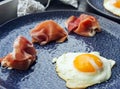 Fried eggs and jamon on a beautiful plate - a great light breakfast for a loved one. Royalty Free Stock Photo