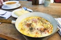 fried eggs in kabardian style in pan and hominy