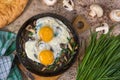 Fried eggs with mushrooms and jusai allium ramosum. Breakfast