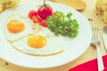 Fried Eggs on a plate on wooden background Royalty Free Stock Photo