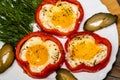 Fried eggs in red peppers on white plate Royalty Free Stock Photo