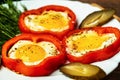Fried eggs in red peppers on white plate Royalty Free Stock Photo