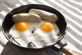 Fried eggs, sausage in iron pan - Healthy food english breakfast