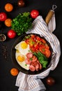 Fried eggs with sausage and vegetables in a frying pan Royalty Free Stock Photo