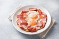 Fried eggs sausages and tomatoes on a plate on the table. Rich homemade Breakfast. Gray concrete background. Copy space Royalty Free Stock Photo