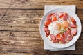 Fried eggs sausages and tomatoes on a plate on the table. Rich homemade Breakfast. Wooden background. Copy space Royalty Free Stock Photo