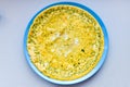 Fried eggs and seasoning. amlet on a round plate. view from above. place for writing Royalty Free Stock Photo