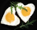 Fried eggs in the shape of a heart in a frying pan Royalty Free Stock Photo