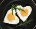Fried eggs in the form of a heart in a skillet Royalty Free Stock Photo