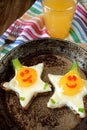Fried eggs shaped as stars with funny faces Royalty Free Stock Photo