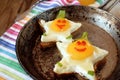 Fried eggs shaped as stars with funny faces