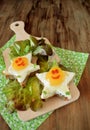 Fried eggs shaped as stars with funny faces
