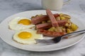 fried eggs with spam sticks and home fries