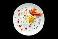 Fried eggs with sprouting onion and red bell pepper on a white p