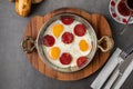 Fried eggs with turkish sausage with bread and tea on dark stone table Royalty Free Stock Photo
