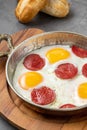 Fried eggs with turkish sausage with bread and tea on dark stone table Royalty Free Stock Photo