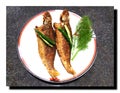 They are fried fish,arranged on white plate. Royalty Free Stock Photo