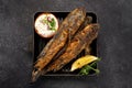 Fried fish Black Sea goby, on a dark background Royalty Free Stock Photo