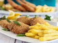 Fried Fish and Chips served in dish isolated on table closeup top view of grilled seafood Royalty Free Stock Photo