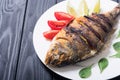 Fried fish dorado with lime , tomatoes and spinach Royalty Free Stock Photo