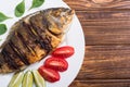 Fried fish dorado with lime , tomatoes and spinach Royalty Free Stock Photo