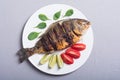 Fried fish dorado with lime tomatoes and spinach . Sea food background Royalty Free Stock Photo