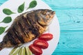 Fried fish dorado with lime , tomatoes and spinach . Sea food Royalty Free Stock Photo