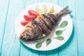 Fried fish dorado with lime , tomatoes and spinach . Sea food Royalty Free Stock Photo