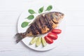 Fried fish dorado with lime , tomatoes and spinach Royalty Free Stock Photo