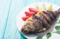 Fried fish dorado with lime , tomatoes and spinach Royalty Free Stock Photo