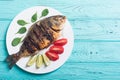 Fried fish dorado with lime , tomatoes and spinach Royalty Free Stock Photo