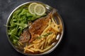 Fried fish dorado with potatoes chips, fresh herbs and lemon Royalty Free Stock Photo