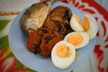 Fried fish and eggs on plate. Royalty Free Stock Photo