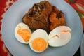 Fried fish and eggs on plate. Royalty Free Stock Photo