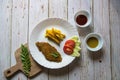 Fried fish fillet along with french fries in a plate and sauce condiments Royalty Free Stock Photo