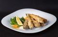 Fried fish gobies in batter with lemon and greens Royalty Free Stock Photo