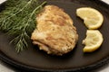 fried fish with lemon and herbs in a frying pan on the table Royalty Free Stock Photo