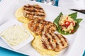 Fried fish patties served with vegetables, salad and greens and mashed potatoes according Royalty Free Stock Photo