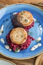 Fried fish rissole served with beetroot on blue plate on wooden table Royalty Free Stock Photo