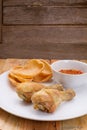 Fried fish sauce marinated chicken drumstick and sauce on white Royalty Free Stock Photo