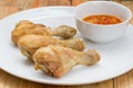 Fried fish sauce marinated chicken drumstick and sauce on white Royalty Free Stock Photo