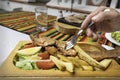 Fried fish served with french fries and salad with a hand sticking a fork on the plate Royalty Free Stock Photo