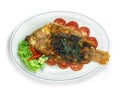 Fried Fish with Spicy Sauce ontop crispy Basil Thai Food Royalty Free Stock Photo