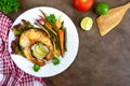 Fried fish steak with grilled vegetables on a white plate. Proper nutrition. Royalty Free Stock Photo